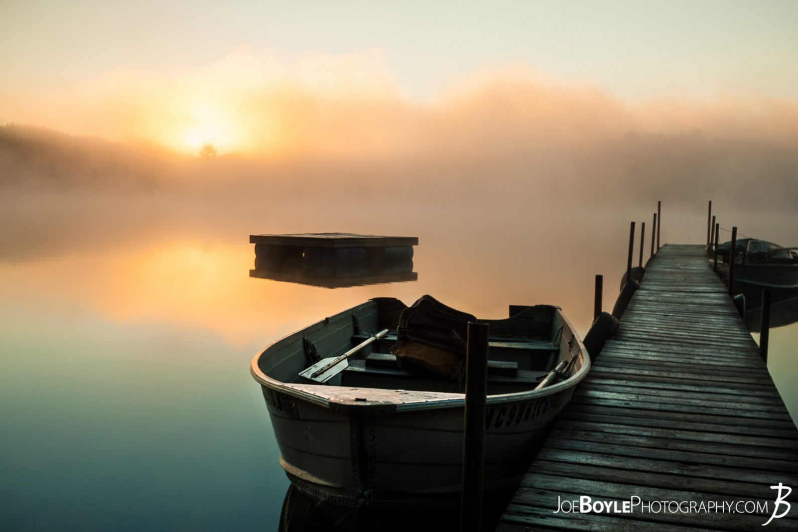calm-misty-lake-with-pier-and-boats-boat-close