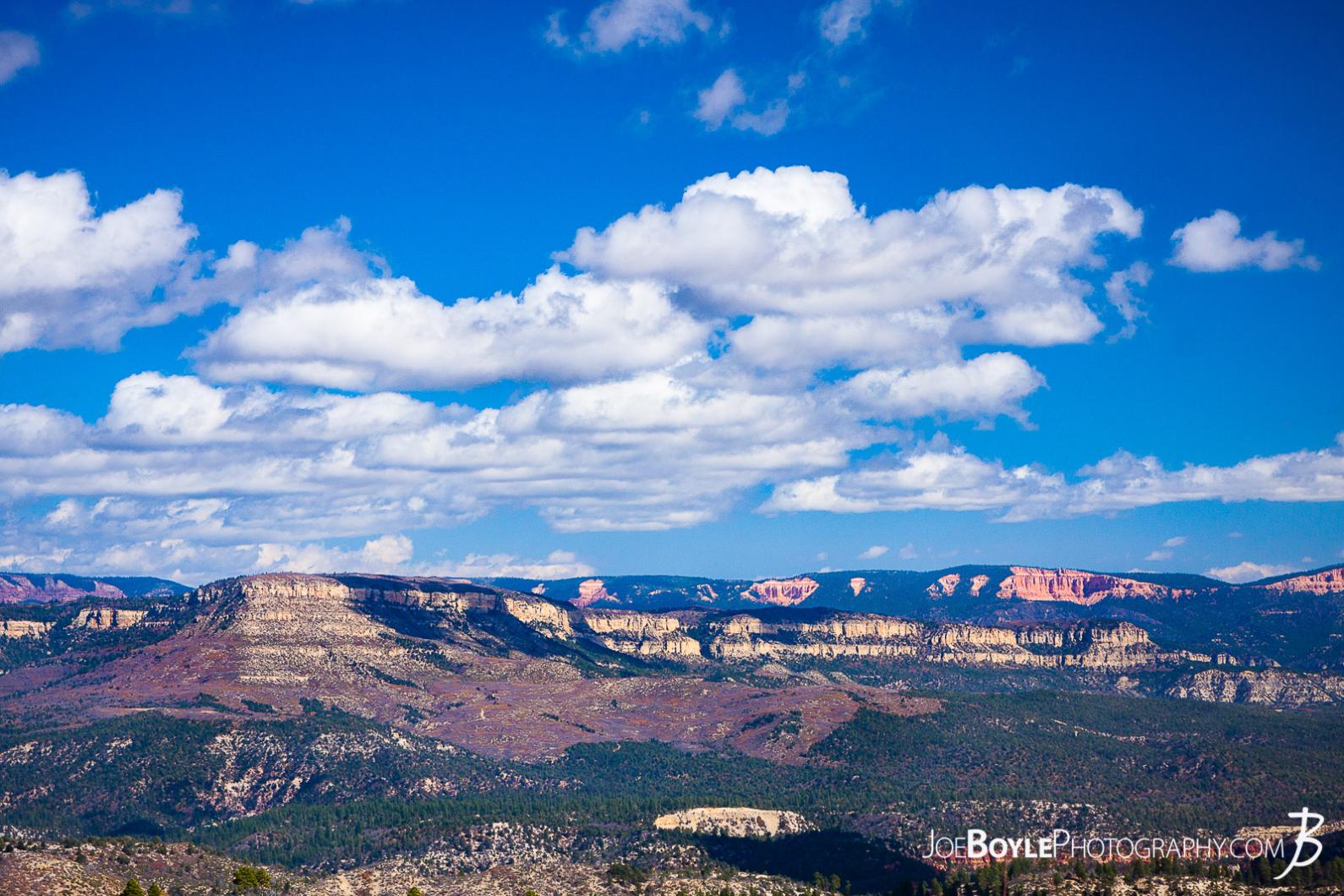 This is a photo of a beautiful blue sky, awesome clouds & canyons in Zion National Park.